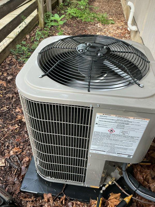 Performed routine maintenance inspection on outdoor air conditioning condenser unit. Unit operational and positioned on concrete pad with proper clearance. Documented current system condition with photos showing beige metal housing, top-mounted fan assembly with protective grille, and refrigerant lines properly routed from unit. Noted accumulation of leaves and organic debris around unit base requiring future attention. Customer requested conversion from monthly payment plan to annual membership billing and scheduling for fall maintenance visit.