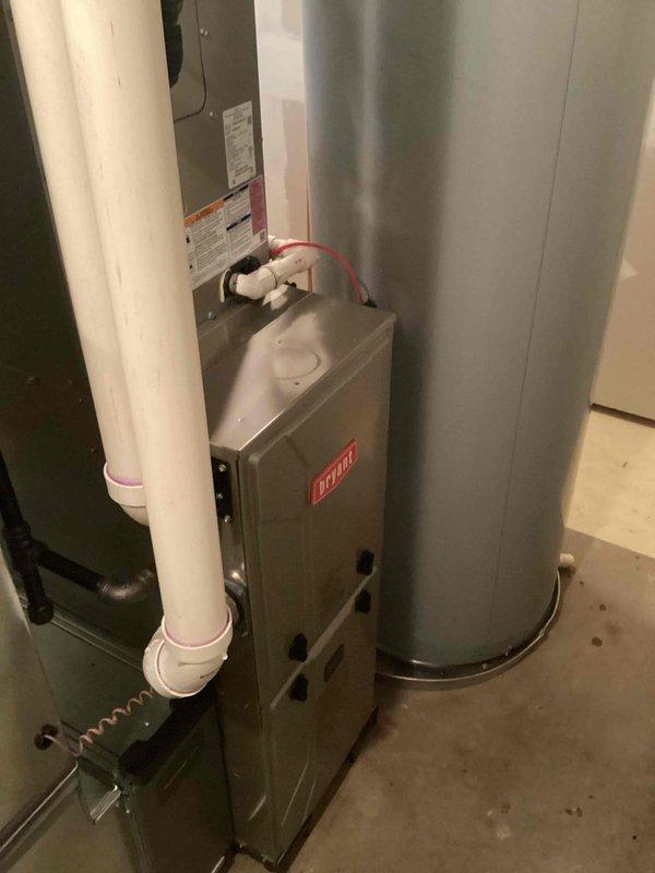 Completed gas furnace tuneup and investigated customer complaint of inadequate heating and cooling to upstairs room. Performed standard maintenance protocol including inspection of Lennox furnace system, verified proper operation of all components, and examined ductwork distribution. Documented equipment condition with photos showing furnace, control panel, venting system, and associated HVAC infrastructure in basement mechanical room.