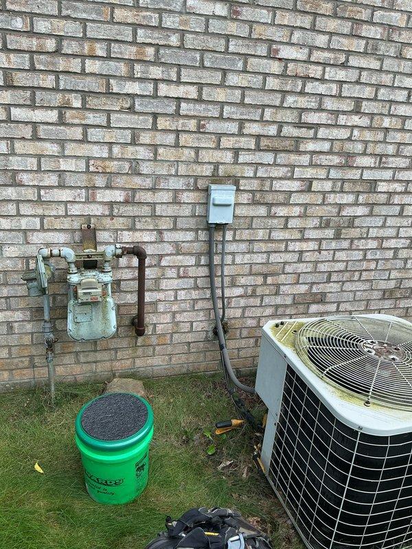 Responded to no cooling call on residential split system air conditioning unit. Upon arrival, confirmed unit had experienced frozen evaporator coil condition, which had been powered off by homeowner to allow thawing. Performed diagnostic evaluation of outdoor condensing unit and associated refrigerant lines. Inspected condenser coil condition, electrical connections at disconnect box, and refrigerant line set routing along exterior wall. System showed signs of age-related wear consistent with 10+ year operation. Documented equipment condition with photographs for service records. Identified frozen line condition as symptom requiring further investigation of potential airflow restriction, refrigerant charge level, or metering device malfunction once system fully thawed and operational testing could be performed.