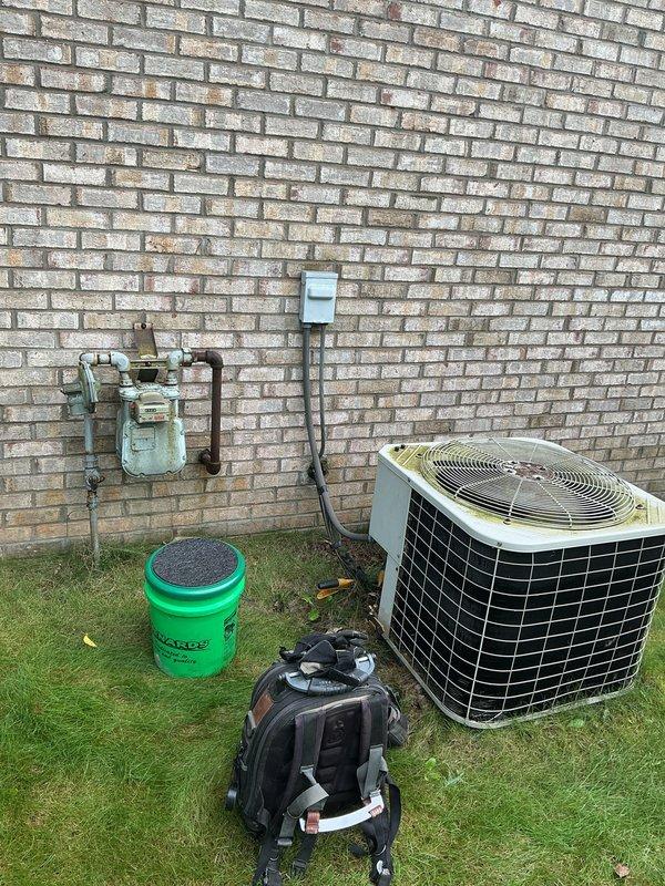 Responded to no cooling call on residential split system air conditioning unit. Upon arrival, confirmed unit had experienced frozen evaporator coil condition, which had been powered off by homeowner to allow thawing. Performed diagnostic evaluation of outdoor condensing unit and associated refrigerant lines. Inspected condenser coil condition, electrical connections at disconnect box, and refrigerant line set routing along exterior wall. System showed signs of age-related wear consistent with 10+ year operation. Documented equipment condition with photographs for service records. Identified frozen line condition as symptom requiring further investigation of potential airflow restriction, refrigerant charge level, or metering device malfunction once system fully thawed and operational testing could be performed.