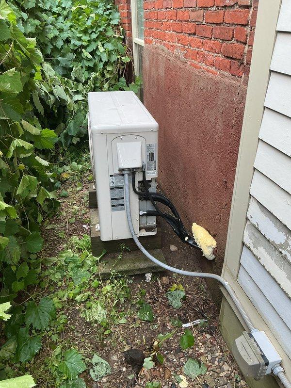 Responded to service call for mini split system experiencing water leakage from indoor unit and intermittent error codes causing system shutdown. Inspected indoor evaporator unit and outdoor condensing unit, documented equipment condition and installation location. Unit was operational and cooling at time of inspection, though customer reported recurring error messages that disable the system randomly. Performed diagnostics and completed necessary repairs to address the water dripping issue and resolve error code problems.