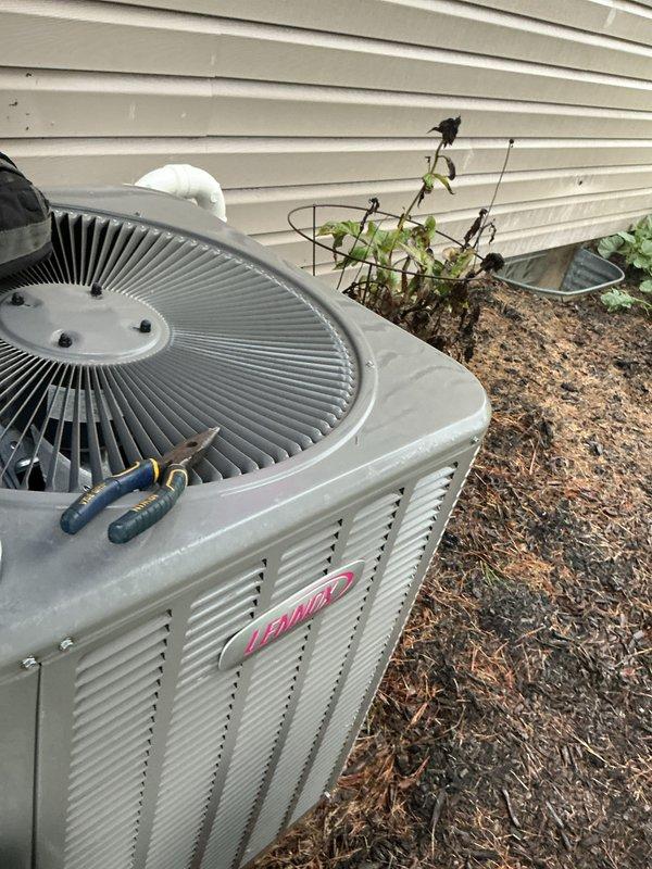 Completed scheduled air conditioning tune-up on Lennox condensing unit. Performed comprehensive maintenance inspection, verified system operation in cooling mode, and documented unit condition with exterior photos showing proper installation and adequate clearance from landscaping.