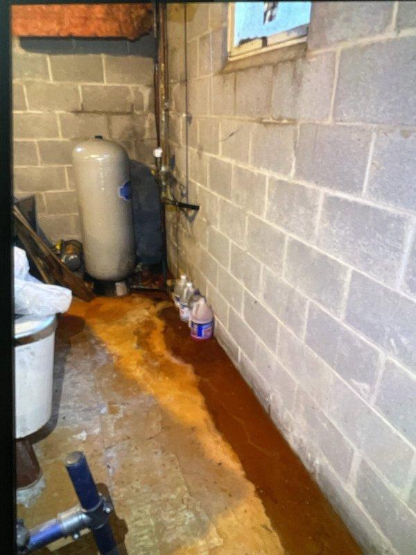 Responded to third service call for non-operational AC system under warranty. Upon arrival, discovered significant water damage in basement utility area with extensive rust-colored staining on concrete floor surrounding HVAC equipment, indicating chronic condensate drainage issues. Inspected electrical panel and found compromised wiring conditions due to moisture exposure. Identified failed condensate pump as root cause of recurring system failures, leading to water accumulation and safety concerns with electrical components. Replaced defective condensate pump, cleared drain lines, tested system operation, and verified proper drainage flow. Recommended monitoring for additional water intrusion and potential electrical panel evaluation due to previous water exposure.