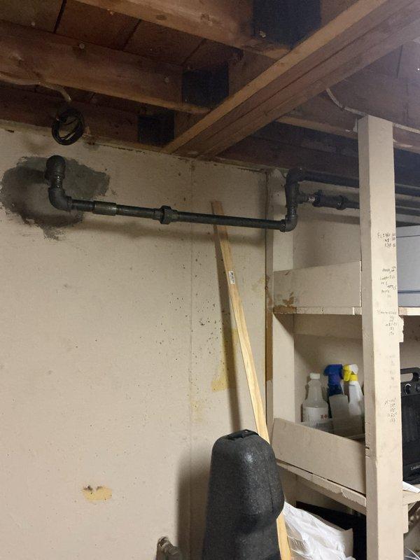 Responded to gas leak marked by utility company at residential property. Upon inspection, located leak at gas pipe connection in basement utility area. Tightened connection fitting and verified seal integrity to resolve leak condition.