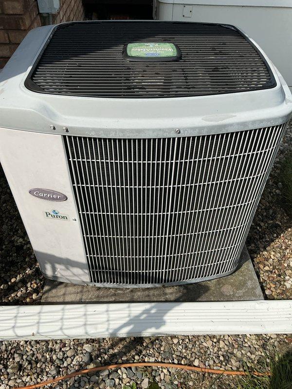 Performed scheduled general maintenance on Carrier air conditioning system with Puron refrigerant. Inspected outdoor condensing unit, verified proper operation of condenser coil and protective components, and confirmed unit integrity with no visible damage or deterioration noted. System operational and functioning within normal parameters upon completion.