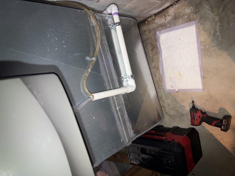 Responded to service call for condensate pump leak and unit not cooling. Upon inspection, found condensate drainage system issue at air handler located in basement utility area. Addressed leaking condensate pump, verified proper drainage through PVC trap assembly, and checked air filter condition. System tested and returned to normal cooling operation with no active leaks present at time of departure.
