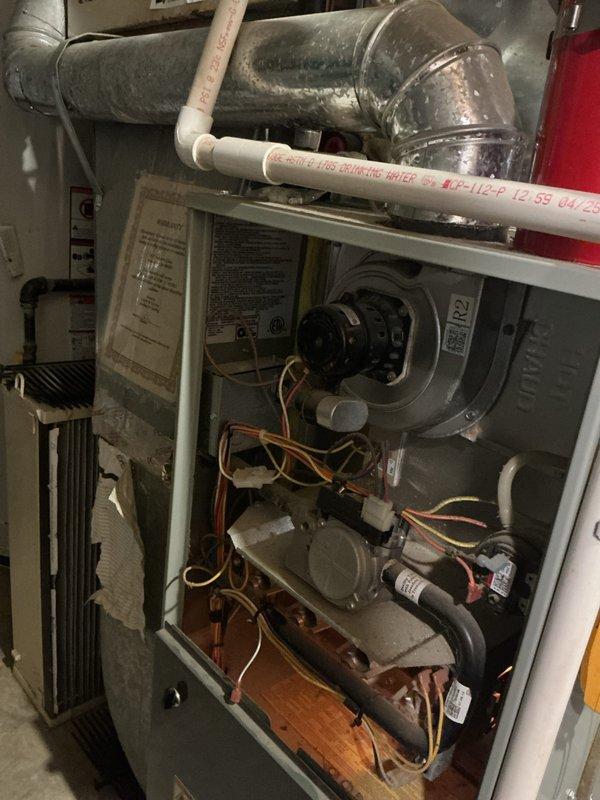 Performed comprehensive tune-up and maintenance on multi-zone HVAC system including air conditioning and gas furnace units. Inspected internal components, blower motor assembly, electrical connections, and control mechanisms; verified proper operation of all system components. Completed membership enrollment at time of service and documented equipment condition through photographic inspection of furnace interior and mechanical room setup.
