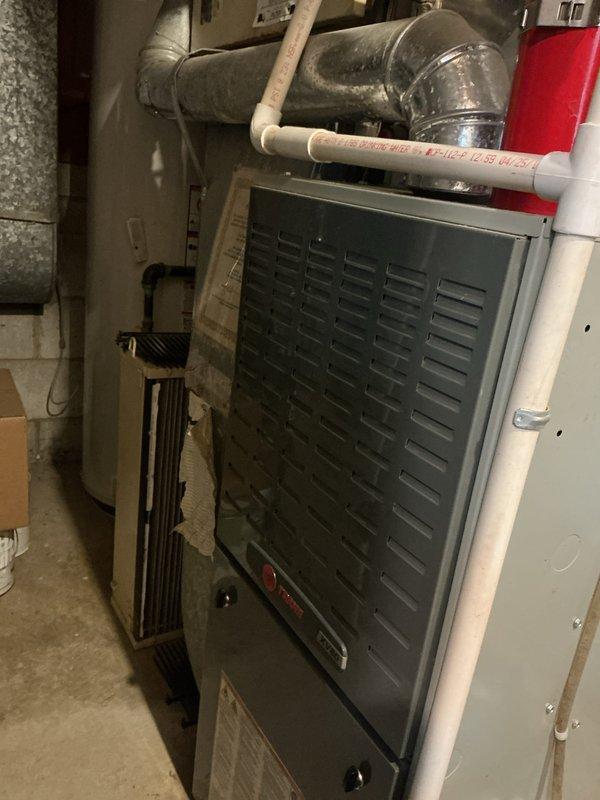 Performed comprehensive tune-up and maintenance on multi-zone HVAC system including air conditioning and gas furnace units. Inspected internal components, blower motor assembly, electrical connections, and control mechanisms; verified proper operation of all system components. Completed membership enrollment at time of service and documented equipment condition through photographic inspection of furnace interior and mechanical room setup.