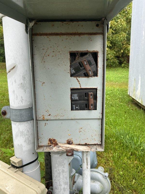 Responded to no cooling complaint at residential property with outdoor condensing unit. Upon arrival, contacted customer via landline as requested before beginning diagnostic assessment. Performed visual inspection of aging AC system exterior components, noting weathered condenser unit with dirt accumulation and discoloration consistent with extended outdoor exposure. Inspected electrical disconnect panel mounted near unit, observing significant rust staining, corrosion, and deterioration from prolonged weather exposure. Documented system condition with photographs showing condenser placement, electrical connections, and overall installation setup. Assessed refrigerant levels and system operation per customer's request to check coolant as potential cause of cooling loss affecting entire home.