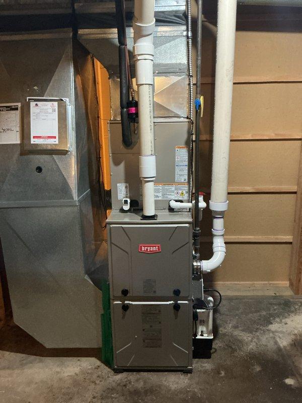 Completed installation of new Bryant air conditioning system with evaporator coil. Installed outdoor condensing unit on gravel pad against exterior wall, connected refrigerant lines with proper insulation, and integrated new evaporator coil with existing furnace system. Ran and secured all refrigerant piping, electrical connections, and PVC condensate drainage lines. System tested, charged to manufacturer specifications, and verified proper operation of all components.