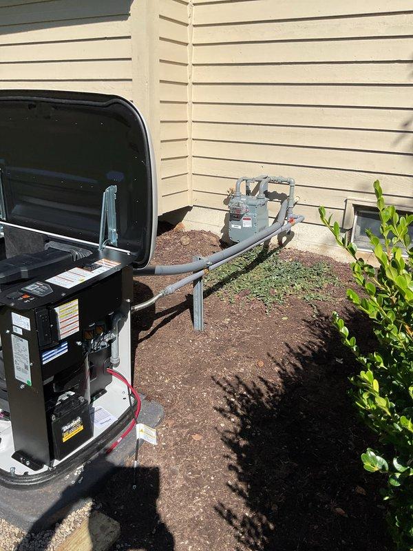 Completed installation of residential standby generator system on concrete pad with proper mounting and clearances. Unit positioned adjacent to existing HVAC equipment with appropriate spacing for service access and ventilation. Installed electrical disconnect box on exterior wall, routed and terminated all electrical connections including power supply wiring to generator control panel. Verified proper grounding, bonding, and compliance with electrical code requirements. Conducted startup procedures, tested automatic transfer switch operation, and confirmed generator functionality under load. All internal components secured, access panels closed, and installation area cleaned of debris.