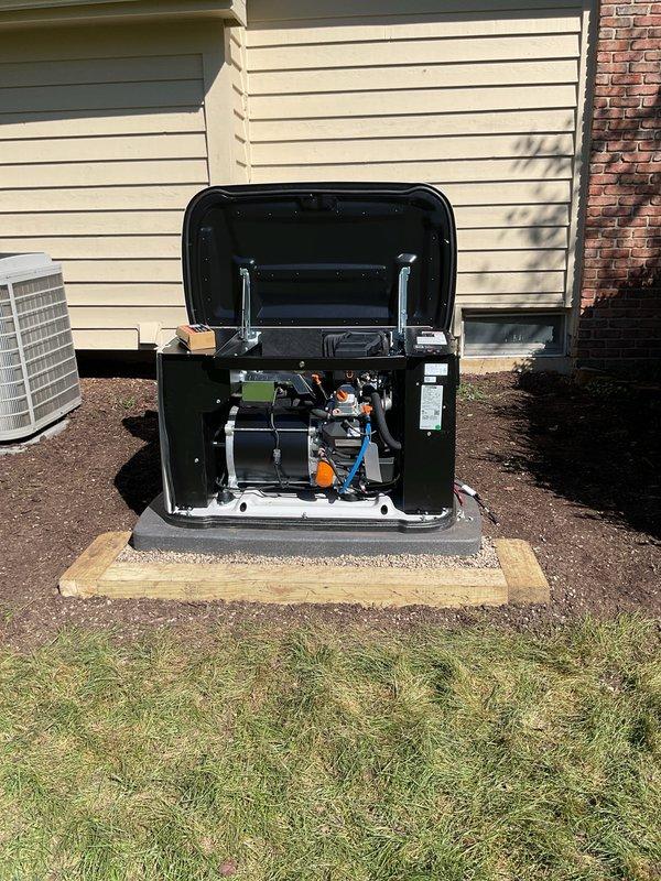 Completed installation of residential standby generator system on concrete pad with proper mounting and clearances. Unit positioned adjacent to existing HVAC equipment with appropriate spacing for service access and ventilation. Installed electrical disconnect box on exterior wall, routed and terminated all electrical connections including power supply wiring to generator control panel. Verified proper grounding, bonding, and compliance with electrical code requirements. Conducted startup procedures, tested automatic transfer switch operation, and confirmed generator functionality under load. All internal components secured, access panels closed, and installation area cleaned of debris.