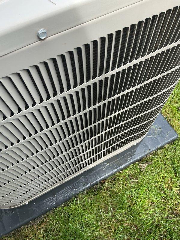 Completed scheduled AC tune-up on residential outdoor condenser unit. Performed comprehensive preventive maintenance inspection, verified proper operation of all components, and documented equipment condition with photographs showing clean coil fins and secure housing panel.
