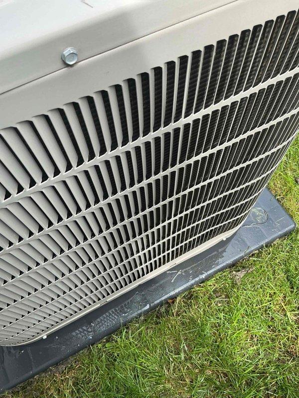 Completed scheduled AC tune-up on residential outdoor condenser unit. Performed comprehensive preventive maintenance inspection, verified proper operation of all components, and documented equipment condition with photographs showing clean coil fins and secure housing panel.