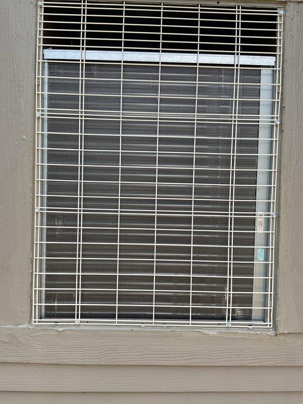 Installed NCP through-the-wall air conditioning unit and Bryant evaporator coil. Adjusted condenser unit to sit flush with exterior trim and applied matching color sealant per HOA requirements. Completed final caulking around unit perimeter to ensure proper weatherproofing and aesthetic integration with existing building facade.
