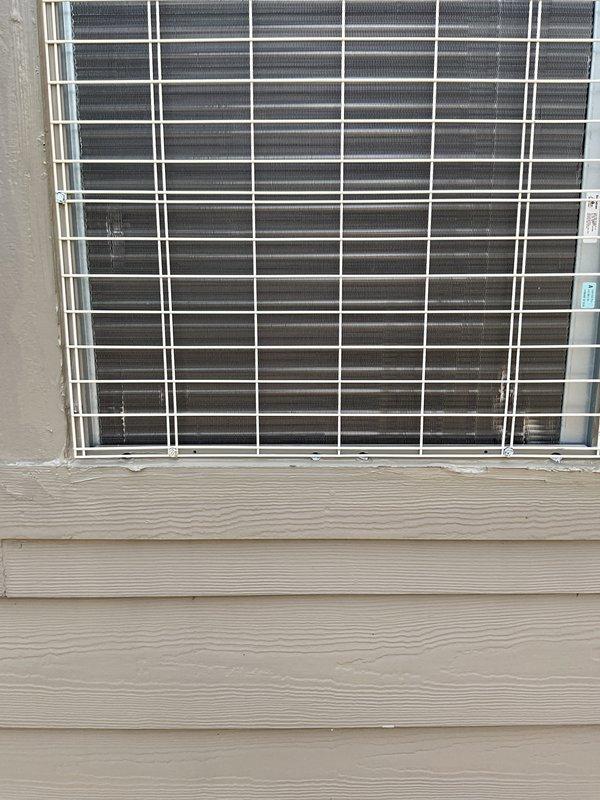 Installed NCP through-the-wall air conditioning unit and Bryant evaporator coil. Adjusted condenser unit to sit flush with exterior trim and applied matching color sealant per HOA requirements. Completed final caulking around unit perimeter to ensure proper weatherproofing and aesthetic integration with existing building facade.