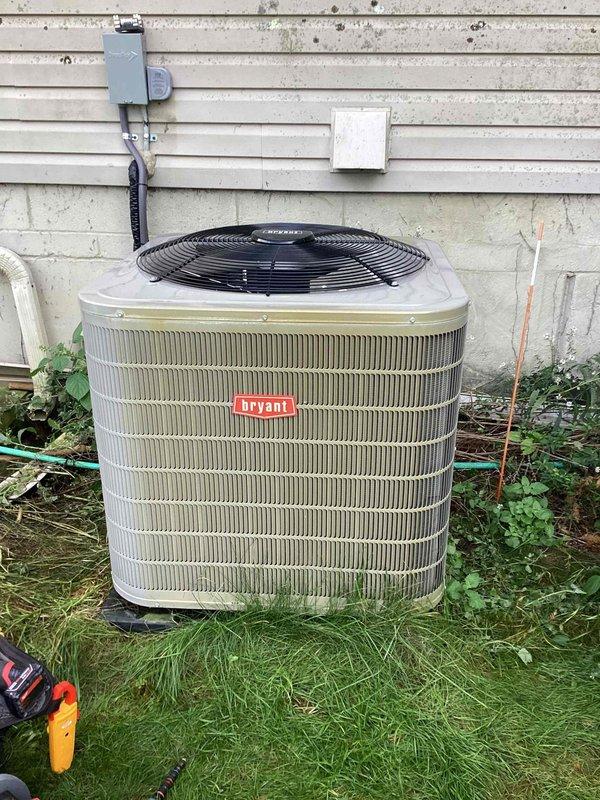 Completed full warranty replacement of Bryant air conditioning unit at residential property. Removed failed existing system and installed new Bryant AC unit on concrete pad against exterior wall. Positioned unit with proper clearances from building siding and vegetation. Installed electrical disconnect box on exterior wall with appropriate conduit routing. Connected refrigerant lines with proper insulation on suction line. Performed startup procedures and verified system operation. Measured voltage at 36.8V during diagnostic testing to confirm proper electrical connections. Inspected condenser fan operation and verified fan guard installation. System tested and operating within manufacturer specifications. Customer expressed satisfaction with completed warranty replacement. Unit left in full operational condition.