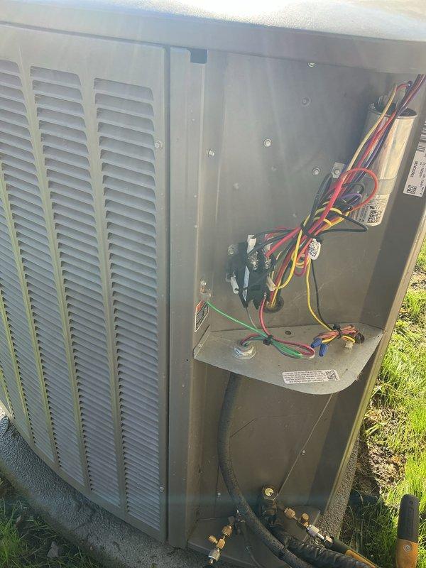 Completed comprehensive AC tune-up and system evaluation on outdoor condensing unit. Performed electrical diagnostics with clamp meter, recording compressor amperage at 92.7 amps, inspected contactor operation, verified all electrical connections and wiring harnesses, and confirmed proper system function. All components operating within normal parameters.