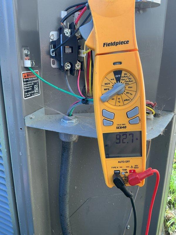 Completed comprehensive AC tune-up and system evaluation on outdoor condensing unit. Performed electrical diagnostics with clamp meter, recording compressor amperage at 92.7 amps, inspected contactor operation, verified all electrical connections and wiring harnesses, and confirmed proper system function. All components operating within normal parameters.