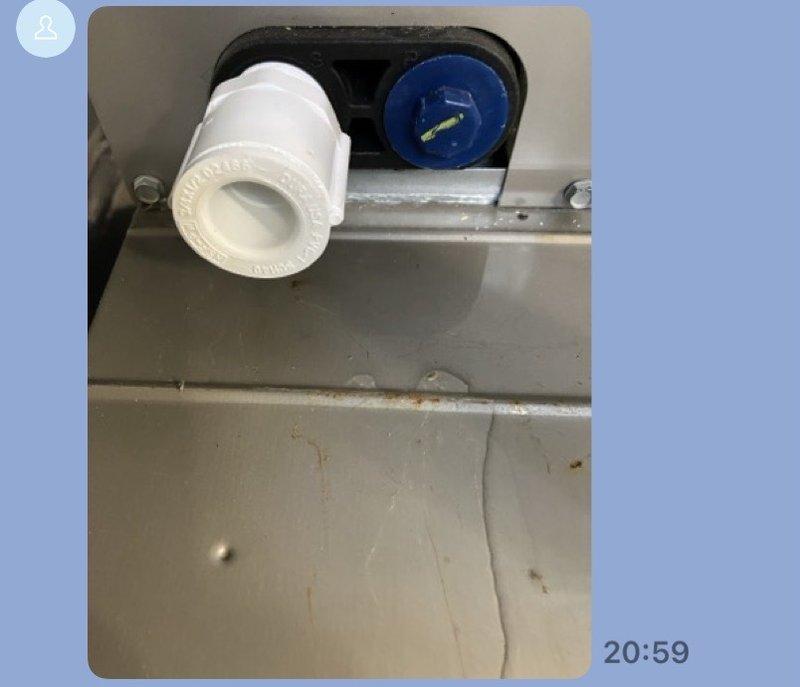 Responded to air conditioning unit leak complaint. Upon inspection, examined refrigerant line connections and drain system components. Documented existing PVC pipe fittings and monitoring equipment mounted to unit housing. Photographed warning labels and refrigerant line connections showing normal wear patterns and minor dust accumulation on system components.