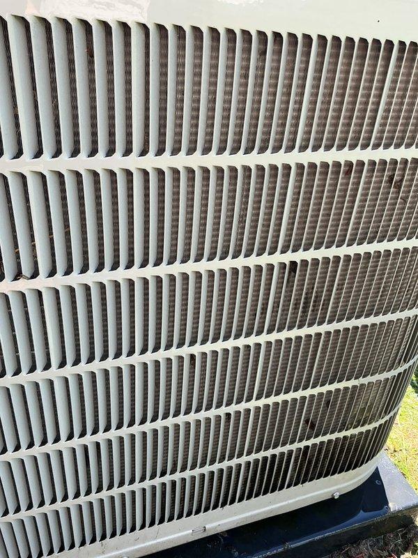 Performed comprehensive AC tune-up on residential outdoor condenser unit. Completed system inspection, verified proper operation of all components, and connected manifold gauges to check refrigerant pressures and system performance. Unit fins showed normal accumulation of outdoor debris but remained in functional condition with adequate airflow through the coil assembly.