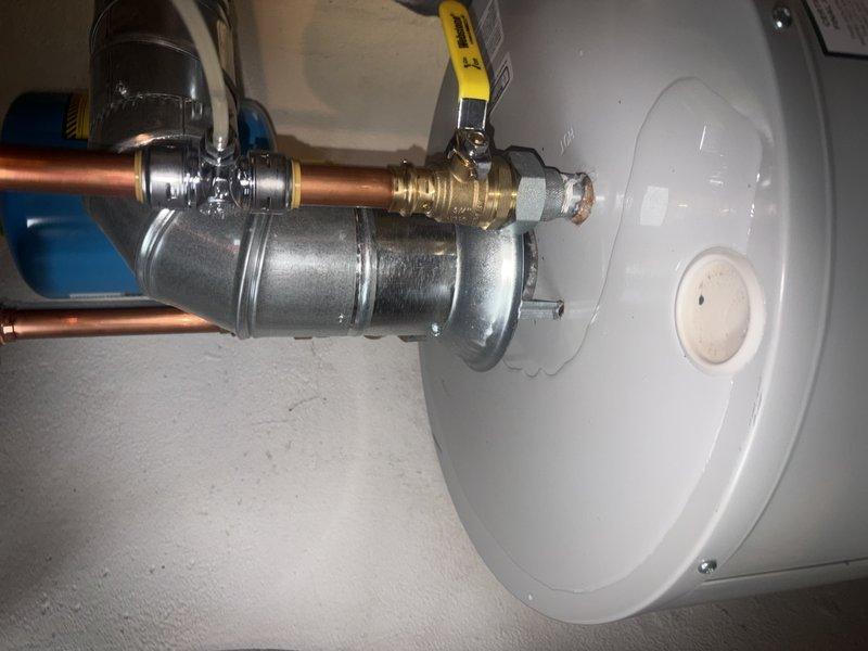 Responded to water heater leak in basement. Upon inspection, identified active leak at cold water inlet connection on top of water heater tank. Brass ball valve and associated fittings showed signs of deterioration and improper sealing at threaded connections. Tightened compression fittings and replaced faulty valve assembly to stop water discharge. Verified all plumbing connections under sink were secure and inspected surrounding fixtures for additional moisture intrusion. System tested and confirmed leak-free operation with full water pressure restored.
