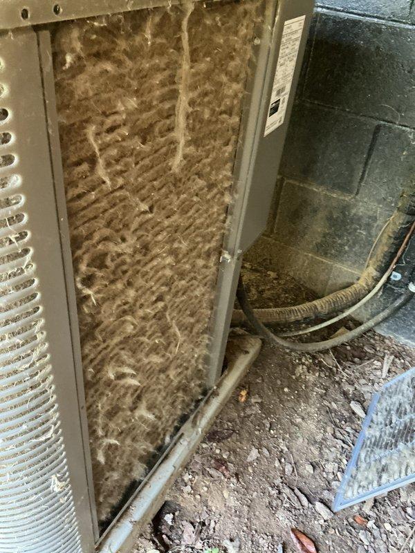 Responded to no-cooling complaint on residential air conditioning system under warranty. Upon inspection, found outdoor condenser unit with heavily soiled coil fins restricting airflow and indoor air handler with severely clogged air filter reducing system capacity. Condenser fan motor operational but unit unable to achieve proper cooling due to restricted airflow at both indoor and outdoor components. Cleaned condenser coil to restore heat transfer efficiency and replaced dirty air filter to restore proper system airflow. Verified system operation with adequate cooling restored and advised homeowner on regular filter maintenance to prevent future performance issues.