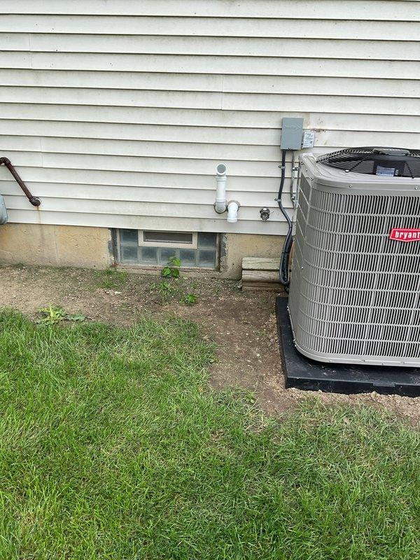 # HVAC System Installation

Successfully completed a full residential HVAC system installation including a new gas furnace, central air conditioning unit, and whole-home humidifier. The outdoor condensing unit was positioned on a rubber isolation pad with proper clearances from the foundation, and electrical disconnect and refrigerant lines were professionally routed along the exterior wall. Interior installation included mounting the gas furnace, integrating the humidifier into the ductwork, and establishing all necessary condensate drainage through PVC piping with proper pitch and termination points.
