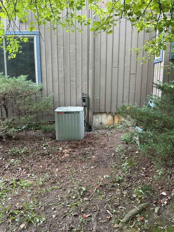 Responded to service call for air conditioning unit not cooling properly. Upon arrival, found 15-year-old Trane XE 1000 system with evaporator coil freezing issue. Coil was thawed at time of inspection. Performed diagnostic evaluation to identify root cause of freezing condition. Assessed airflow, refrigerant levels, and system operation. Documented unit condition with photos showing outdoor condenser placement and electrical disconnect. Collected service fee and provided customer with repair recommendations. Follow-up appointment scheduled to address necessary repairs and prevent future coil freezing.