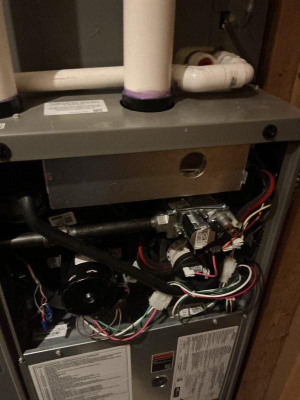 Completed complimentary air conditioning and gas furnace tune-up per installation agreement. Performed comprehensive maintenance inspection of furnace unit, verified all internal components including blower motor assembly, gas valve, and electrical connections are functioning properly with no signs of damage or deterioration. Documented equipment condition with service photos showing proper installation of PVC venting, secure wire harnesses, and accessible manufacturer specification labels for future reference.