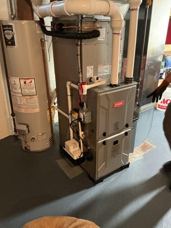 Completed full HVAC system installation in residential basement, including new Bryant furnace and air conditioning unit. Installed all necessary PVC condensate drainage, refrigerant lines, and electrical connections per manufacturer specifications. Positioned equipment on protective rubber matting, integrated condensate pump, verified proper venting, tested system operation, and ensured all components functioning correctly upon completion.
