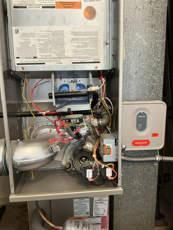 Performed comprehensive multi-system tune-up on Bryant Plus 80 gas furnace and air conditioning system. Inspected and tested all internal components including inducer motor assembly, gas valve, igniter, control board, and Honeywell thermostat. Verified proper operation of electrical connections, safety controls, and airflow through cabinet louvers. Documented equipment condition with detailed photography of internal mechanical and electrical components for service records.
