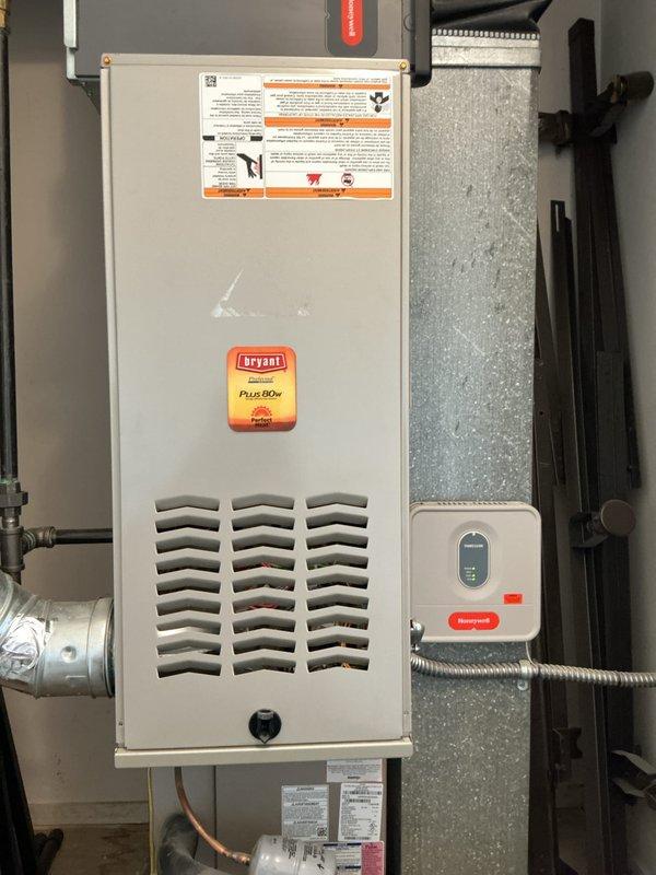 Performed comprehensive multi-system tune-up on Bryant Plus 80 gas furnace and air conditioning system. Inspected and tested all internal components including inducer motor assembly, gas valve, igniter, control board, and Honeywell thermostat. Verified proper operation of electrical connections, safety controls, and airflow through cabinet louvers. Documented equipment condition with detailed photography of internal mechanical and electrical components for service records.