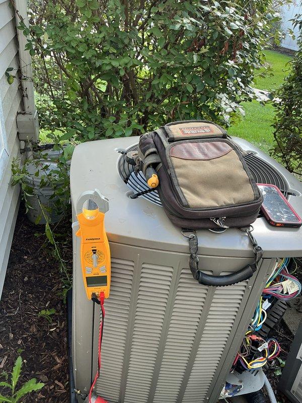 Completed comprehensive AC tune-up on outdoor condensing unit, performing standard maintenance procedures including electrical system inspection, component testing with diagnostic meter, and verification of proper operation. All systems tested within normal parameters and unit returned to service in good working condition.