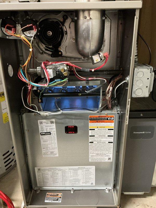 Completed scheduled air conditioning tune-up and standard maintenance service on residential split system. Performed comprehensive inspection of indoor furnace unit including blower motor assembly, gas valve components, electrical connections, and control systems; all components found operating within normal parameters. Inspected outdoor condenser unit, noting weathering and dirt accumulation on exterior fins with water runoff staining; unit operational with adequate airflow through coil sections.
