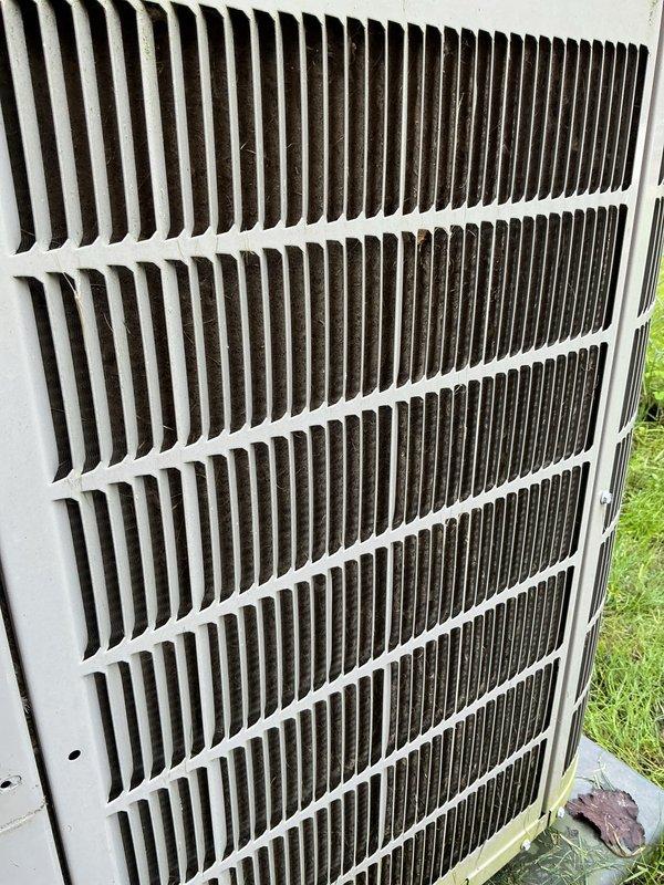 Completed scheduled air conditioning tune-up and preventative maintenance service on outdoor condensing unit. Performed comprehensive system inspection, documenting equipment condition with detailed photography of exterior cabinet and grille assembly showing normal weathering and dirt accumulation on louvers and fins. Verified unit operational status and completed all standard maintenance protocol items per manufacturer specifications.