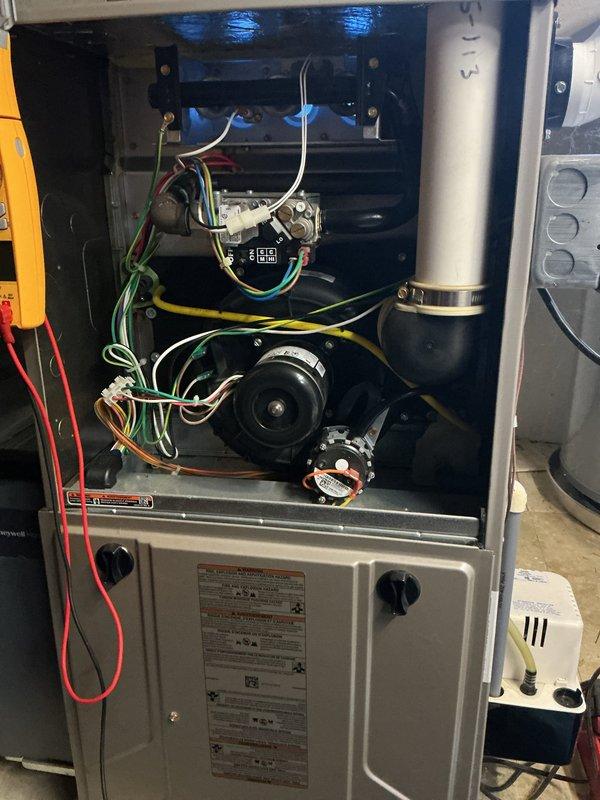 Completed comprehensive tune-up on residential HVAC system including 5-year-old furnace located in basement and 23-year-old outdoor air conditioning condenser unit. Performed full system diagnostics with electrical testing on furnace components, inspected blower motor assembly, verified all electrical connections and control relays, and confirmed proper operation of all internal components. Conducted exterior condenser inspection and maintenance, noting unit accessibility partially restricted by vegetation growth around perimeter. Both systems operating within normal parameters with no repairs required at this time.