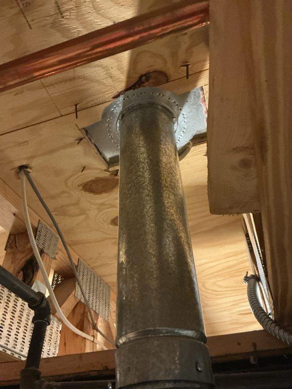 Completed full HVAC system installation including new furnace and air conditioning unit in residential basement location. Installed main air handler unit on concrete floor with proper clearances, connected vertical supply and return ductwork to existing distribution system through ceiling joists, and secured all galvanized metal ductwork with appropriate mounting hardware. Ran copper refrigerant lines from outdoor condensing unit to indoor air handler, installed electrical disconnects and control wiring, and verified all connections meet manufacturer specifications and local code requirements. System tested and operational upon completion.