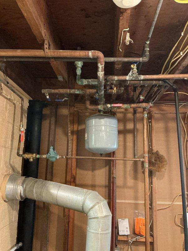 Responded to a no-heat service call on a 20-year-old hydronic boiler system with multiple heating zones experiencing progressive failure. Upon inspection, diagnosed malfunctioning automatic fill valve causing air entrainment throughout the distribution system, resulting in noisy operation in baseboard radiators and sequential zone failure. Serviced the autofill mechanism, purged air from supply and return lines, bled individual zone circuits, verified proper system pressure at expansion tank, and tested all zone valves for proper operation to restore full heating functionality across all zones.