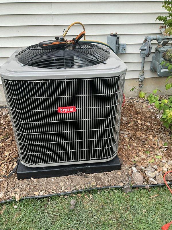 Completed installation of new Bryant air conditioning system including outdoor condensing unit and indoor evaporator coil. Positioned condenser on level pad against exterior wall with proper clearances, established refrigerant line connections with insulated copper tubing routed to indoor air handler, and installed electrical disconnect box for service accessibility. Installed evaporator coil within existing air handler cabinet in basement mechanical room, connected refrigerant lines, and established proper condensate drainage through PVC piping. Performed system startup, verified proper refrigerant charge, confirmed electrical connections meet code requirements, and tested all components for optimal operation and efficiency.
