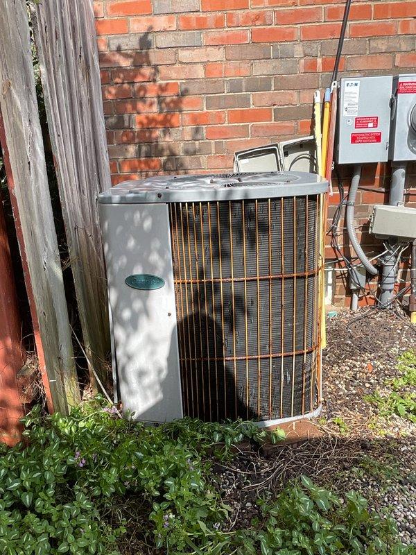 Completed scheduled preventive maintenance tune-up on residential cylindrical air conditioning condenser unit. Performed comprehensive system inspection, verified proper operation of all components, checked refrigerant lines and electrical connections at disconnect box, and documented equipment condition with photos showing unit in satisfactory operating condition with normal weathering for outdoor installation.