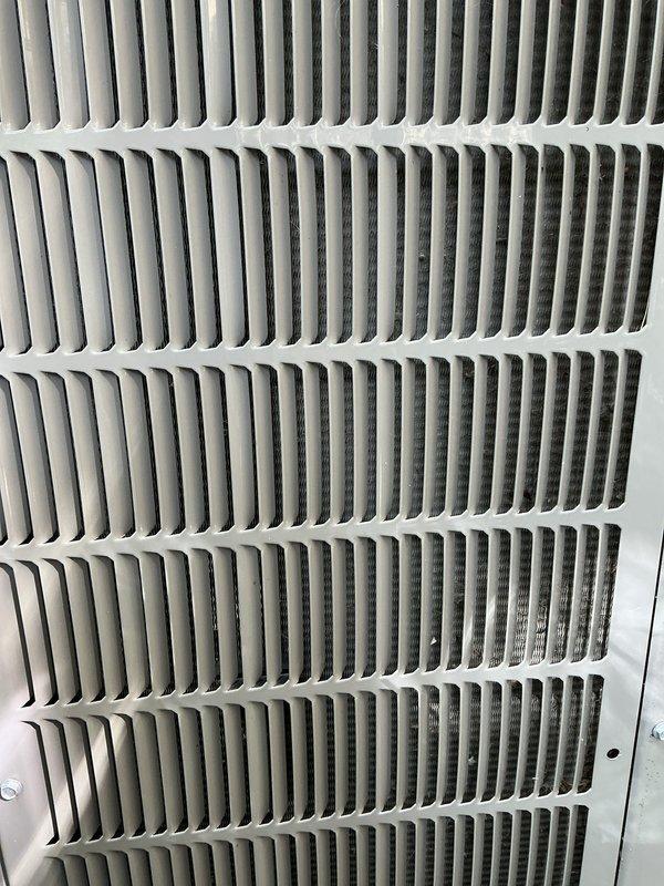 Completed scheduled recurring maintenance service on packaged terminal unit. Inspected exterior louvers and air return grille, documented unit condition with photos showing normal wear and dust accumulation on ventilation components, verified cooling operation restored to proper function.