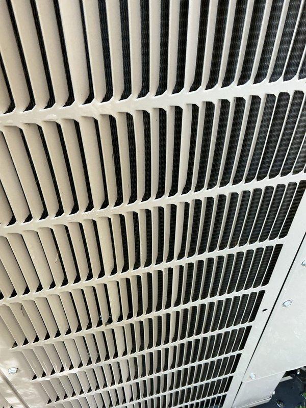 Completed scheduled recurring maintenance service on packaged terminal unit. Inspected exterior louvers and air return grille, documented unit condition with photos showing normal wear and dust accumulation on ventilation components, verified cooling operation restored to proper function.