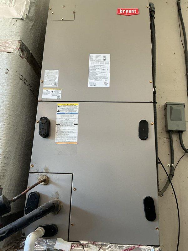 Completed scheduled AC tune-up on Bryant HVAC system located in basement utility room. Performed comprehensive system inspection, verified electrical connections, checked refrigerant levels, and tested system operation with digital multimeter confirming proper voltage readings at 68.2 VAC.