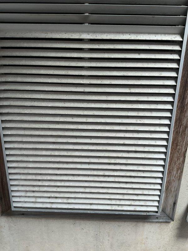 Completed comprehensive AC tune-up and system inspection on residential HVAC unit. Performed routine maintenance including inspection of interior return air grille and exterior ventilation intake unit, noting dust accumulation on filter media and louvers consistent with normal operation. All system components evaluated and found operational within manufacturer specifications.