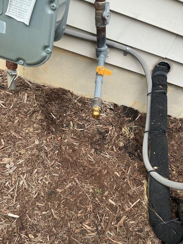 Installed tee fitting on existing natural gas line to provide dedicated fuel supply for portable generator. Work included routing black iron pipe from gas meter, installing appropriate shut-off valve with orange handle for easy identification, and pressure testing all connections to ensure leak-free operation per code requirements.