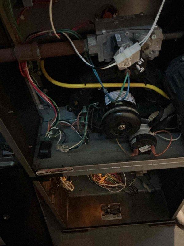 Performed comprehensive furnace tune-up and safety inspection on residential heating system. Conducted thorough examination of all internal components including gas valve assembly, draft inducer motor, blower assembly, heat exchanger, and burner compartment. Verified proper operation of electrical connections, inspected wiring harnesses for wear or damage, and confirmed secure mounting of all mechanical components. Tested gas valve operation, examined copper gas piping for integrity, and inspected white plastic pressure tubing connections. Evaluated combustion chamber and heat exchanger for signs of deterioration or carbon buildup. Confirmed draft inducer motor functionality and checked blower motor operation. All components found to be in functional condition with normal operational wear. System operating safely with no immediate service needs identified at time of inspection.