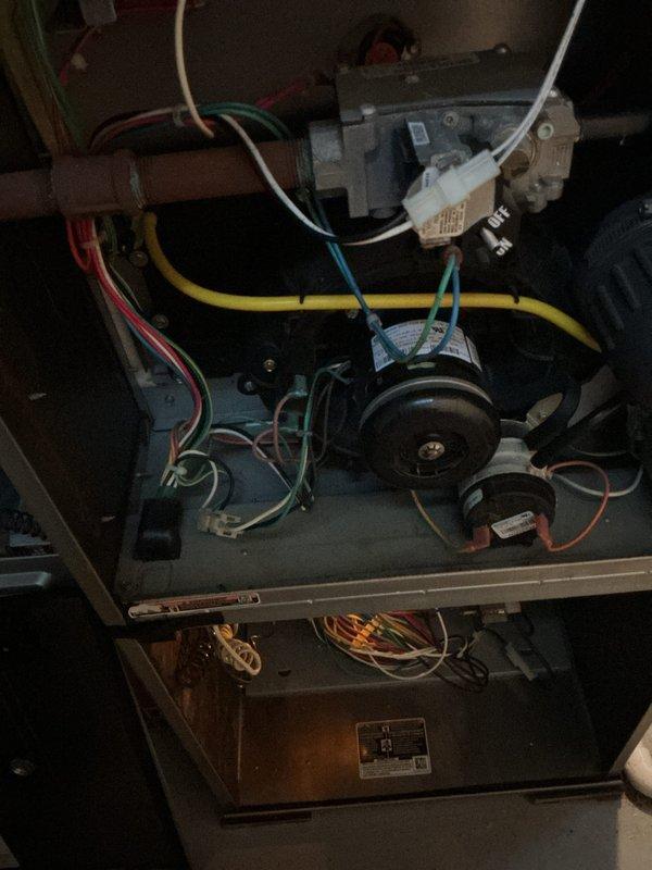 Performed comprehensive furnace tune-up and safety inspection on residential heating system. Conducted thorough examination of all internal components including gas valve assembly, draft inducer motor, blower assembly, heat exchanger, and burner compartment. Verified proper operation of electrical connections, inspected wiring harnesses for wear or damage, and confirmed secure mounting of all mechanical components. Tested gas valve operation, examined copper gas piping for integrity, and inspected white plastic pressure tubing connections. Evaluated combustion chamber and heat exchanger for signs of deterioration or carbon buildup. Confirmed draft inducer motor functionality and checked blower motor operation. All components found to be in functional condition with normal operational wear. System operating safely with no immediate service needs identified at time of inspection.
