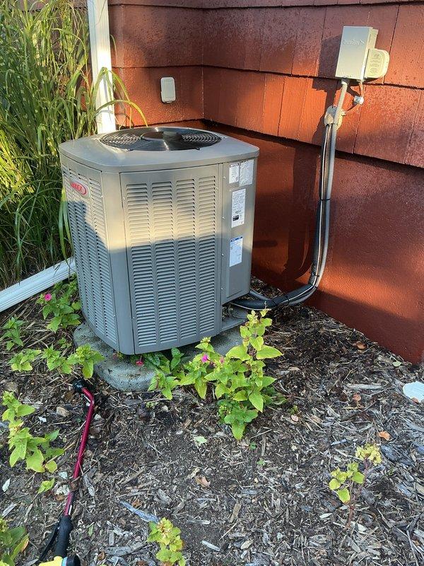 Completed scheduled recurring maintenance service on residential Lennox outdoor condensing unit. Performed comprehensive system inspection, verified proper operation of cooling system, and documented unit condition with exterior photographs showing equipment in good working order with adequate clearances maintained around unit.