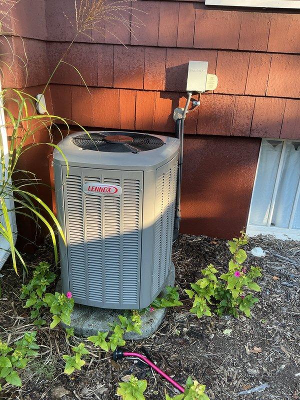 Completed scheduled recurring maintenance service on residential Lennox outdoor condensing unit. Performed comprehensive system inspection, verified proper operation of cooling system, and documented unit condition with exterior photographs showing equipment in good working order with adequate clearances maintained around unit.